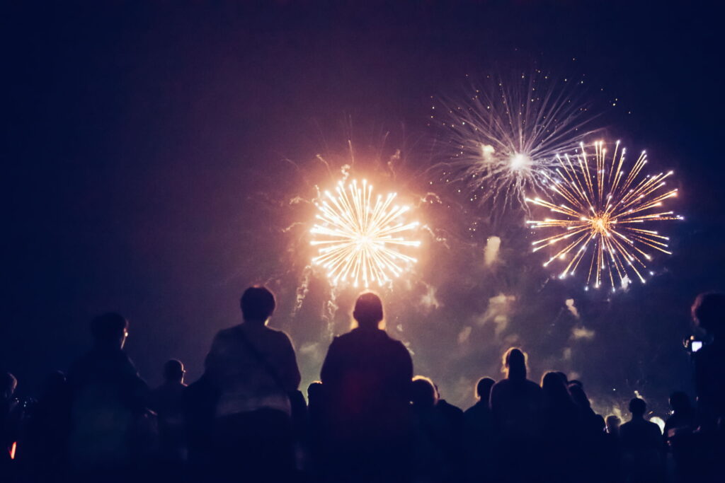 Crowd watching fireworks and celebrating at night