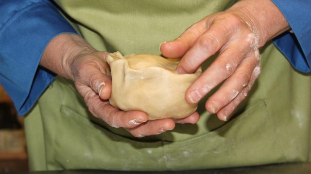 close-up-hands-with-raw-pork-pie.jpg