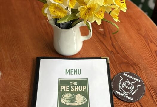 menu on a table with a vase of spring flowers