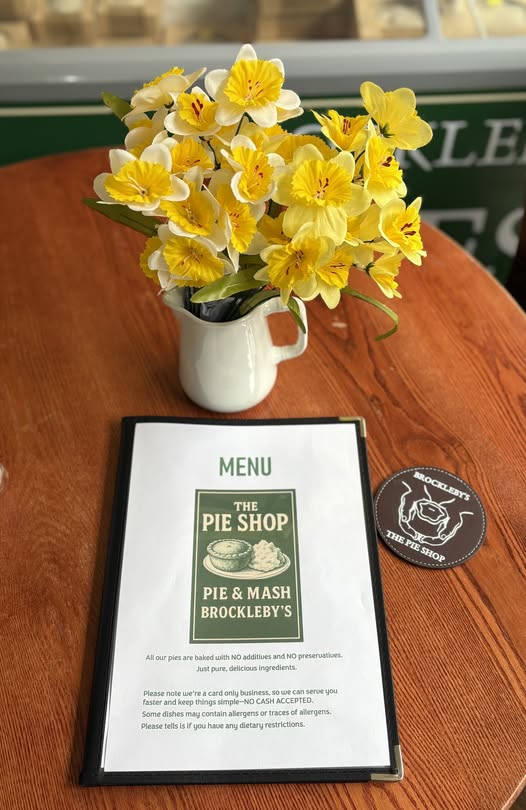 menu on a table with a vase of spring flowers