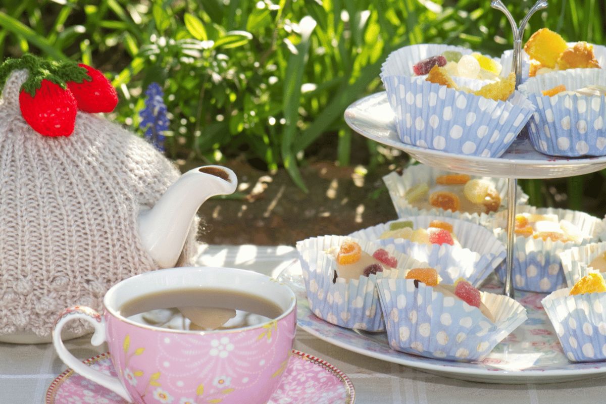 Tea pot, cakes and cup of tea