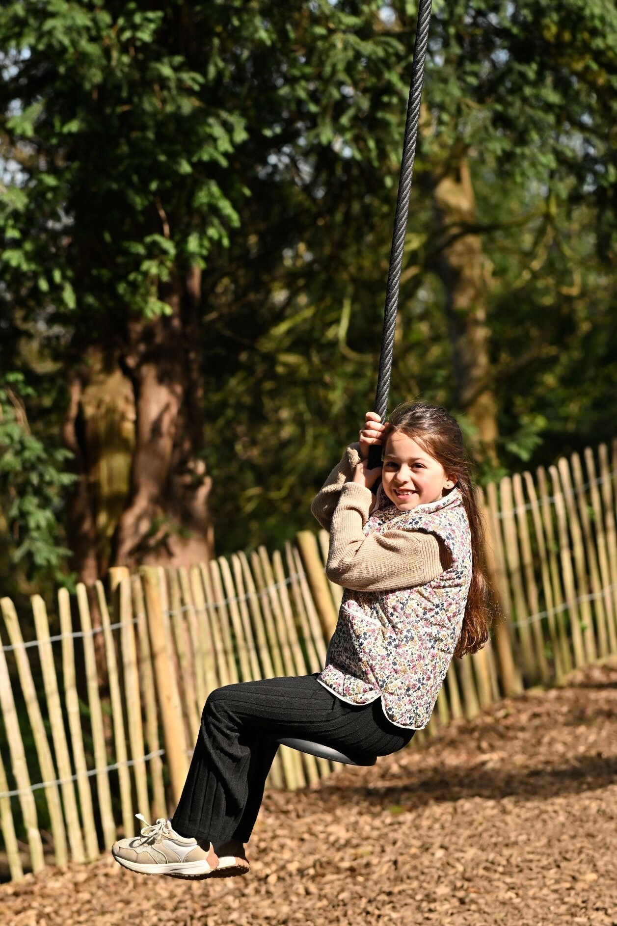 small girl on a swing rope