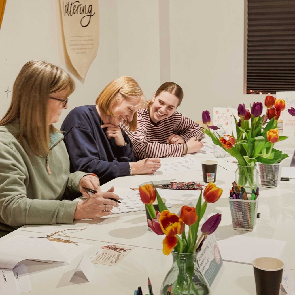 Three adults crafting
