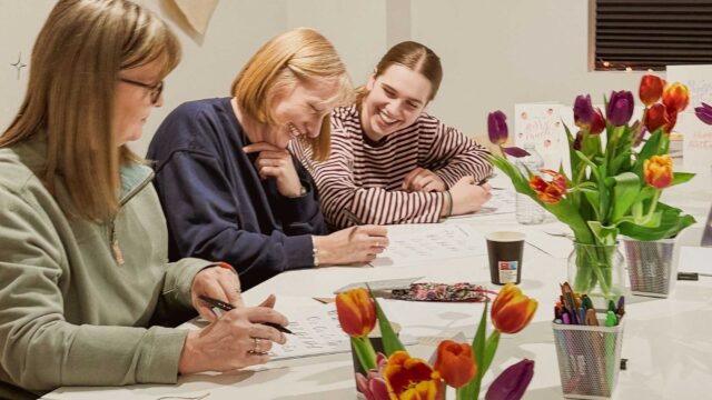 Three adults crafting