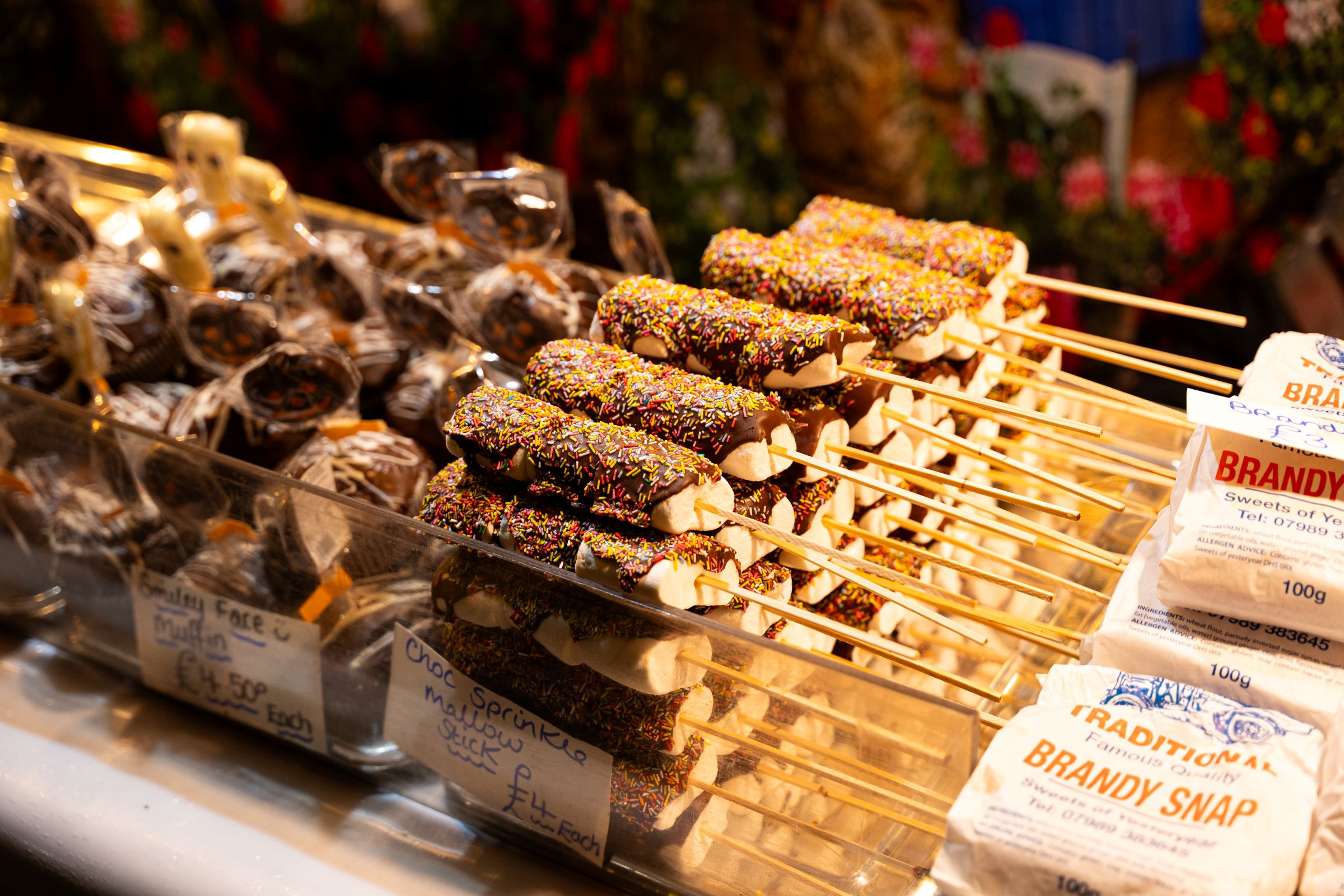 Festive chocolate marshmallow treats at a Christmas market stall.